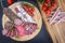 Assorted sliced italian salami on wooden plate