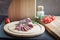 Assorted sliced italian salami on wooden plate