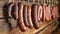 Assorted Smoked Sausages Hanging From Farm Cellar Line