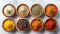 Assorted Spices in Wooden Bowls on Marble Surface