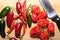 Assorted Spicy Hot Chili Peppers on Cutting Board with Knife