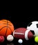 Assorted sports balls on a black background