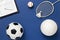 Assorted sports equipment on a blue background with copy space