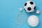 Assorted sports equipment including a basketball, soccer ball, volleyball, baseball, badminton racket on a light blue background