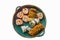 Assorted store bought sushi rolls with some ginger on a rustic platter isolated on white