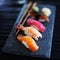 Assorted sushi nigiri on slate