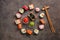 Assorted sushi roll, soy sauce, wasabi and ginger on a dark background. Japanese sushi set, round frame. Top view, flat lay