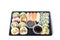 Assorted sushi rolls in a black plastic tray