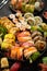 Assorted sushi set served on dark dark background. Top view of seafood, various maki rolls