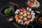 Assorted sushi set served on dark stone slate background