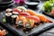 Assorted sushi. Sushi set on slate served with soy. Japanese cuisine