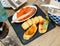 Assorted tapas served on black board in restaurant