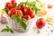 Assorted tomatoes with basil in basket, garlic, spice and raw pasta for italian cuisine. Healthy food concept on white background