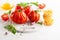 Assorted tomatoes with basil, garlic, spice and raw pasta for italian cuisine. Healthy food concept on white background