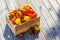 Assorted tomatoes in rustic crate