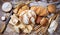 Assorted traditional bread with loaves, rolls and breadsticks on a wooden worktop, top view.