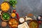 Assorted traditional Indian food on a dark background. Corner frame Indian dish Chicken tikka masala, palak paneer, saffron rice,