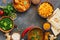 Assorted traditional Indian food on a dark stone background. Frame Indian dish Chicken tikka masala, palak paneer, saffron rice,