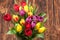 Assorted Tulips Bouquet. Burned Wooden Background. Copy Space