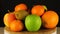 Assorted various fruits rotates on a black background.