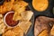 Assorted from various types of potato chips and pita chips, snacks for parties and parties, with salsa and dip. Fast and tasty