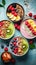 Assorted vegan smoothie bowls with granola, berries, and banana slices, turquoise backdrop