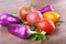 Assorted vegetable with purple exotic color bell peppers and tomatoes on stone background.