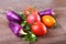 Assorted vegetable with purple exotic color bell peppers and tomatoes on stone background.