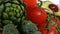 Assorted vegetables rotating on white background