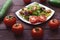 Assorted vegetables on a wooden background. Spicy salad of vegetables and mozzarella