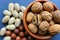 Assorted Walnuts, macadamia nuts and pecans close-up on wooden table