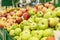 Assortment of apples in the supermarket. Large selection of different varieties. Healthy eating and vegetarianism. Side view