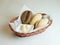 Assortment of baked bread in basket on white background