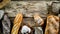 Assortment of baked bread and bread rolls on wooden table background