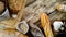 Assortment of baked bread and bread rolls on wooden table background