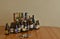 Assortment of beer bottles and cans on table. Drinking at home.