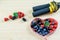 Assortment of berries, dosing tape and  jump rope on the wooden background. Symbols of healthy sport life and fruit balanced