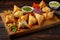 Assortment of bite-sized samosas with various fillings, including spiced vegetables and minced meat, arranged on a wooden platter