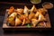 Assortment of bite-sized samosas with various fillings, including spiced vegetables and minced meat, arranged on a wooden platter