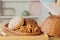 Assortment of breads near a wicker basket on a table in a rustic kitchen. Composition in kitchen at the photo studio