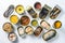 Assortment of canned preserves  food in cans. On white rustic background conserve Saury, mackerel, sprats, sardines, pilchard,