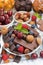 Assortment chocolate, berries and nuts, vertical, closeup