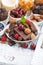 assortment chocolate, berries and nuts on white background