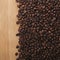 Assortment of coffee beans on textured wooden background, rich aroma