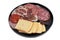 Assortment of cold meats in a plate on white background