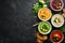 Assortment of colored vegetable cream soups. Dietary food. On a black stone background. Top view.