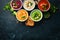 Assortment of colored vegetable cream soups. Dietary food. On a black stone background. Top view.