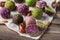 Assortment of colorful bliss balls or energy balls. Vegetarian vegan sugar free sweets on wooden background