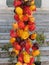 Assortment of colorful chilli peppers hanging outdoor