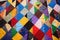 assortment of colorful, hand sewn patchwork quilts